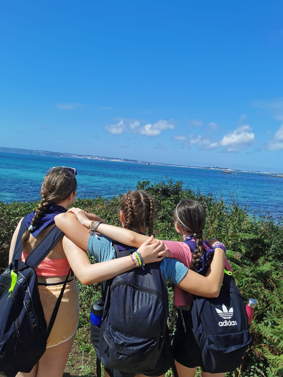 Three scouts looking out to sea