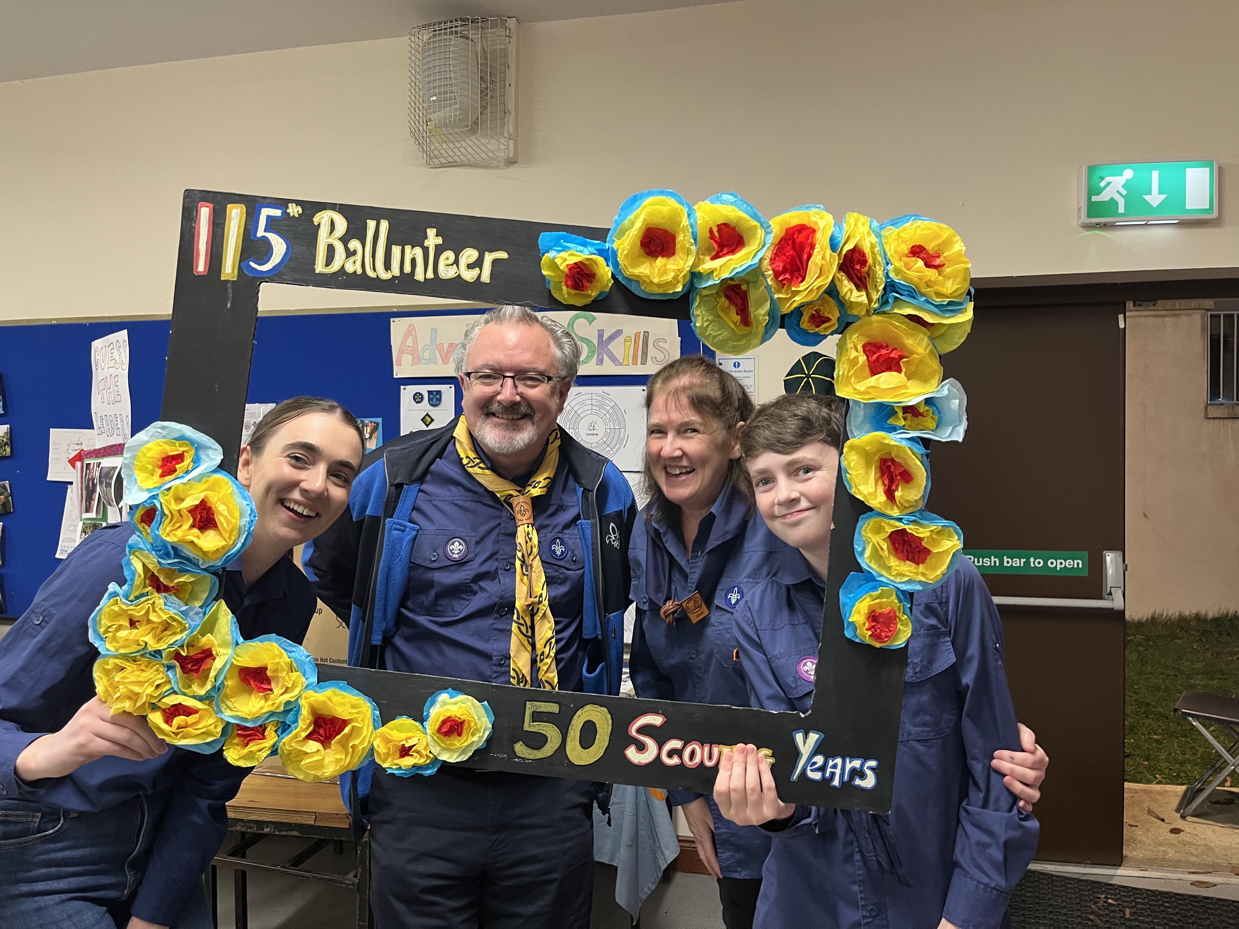 Chief Scout Eoin Callanan with 115th Ballinteer members holding the handmade 50 Scout Years frame