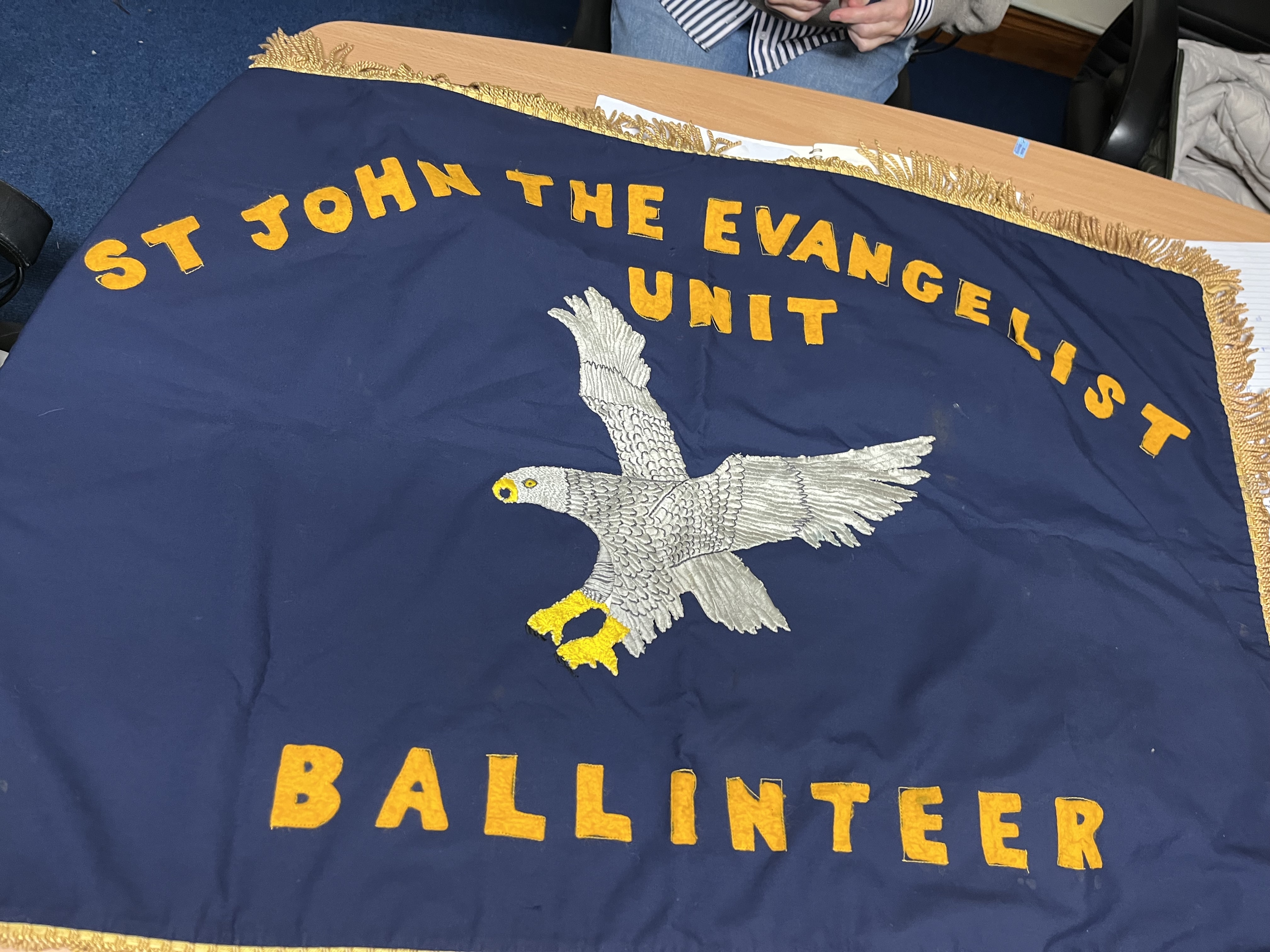 The original 115th Ballinteer flag, handmade by Mrs Kerrigan, showing the Eagle emblem of St John the Evangelist