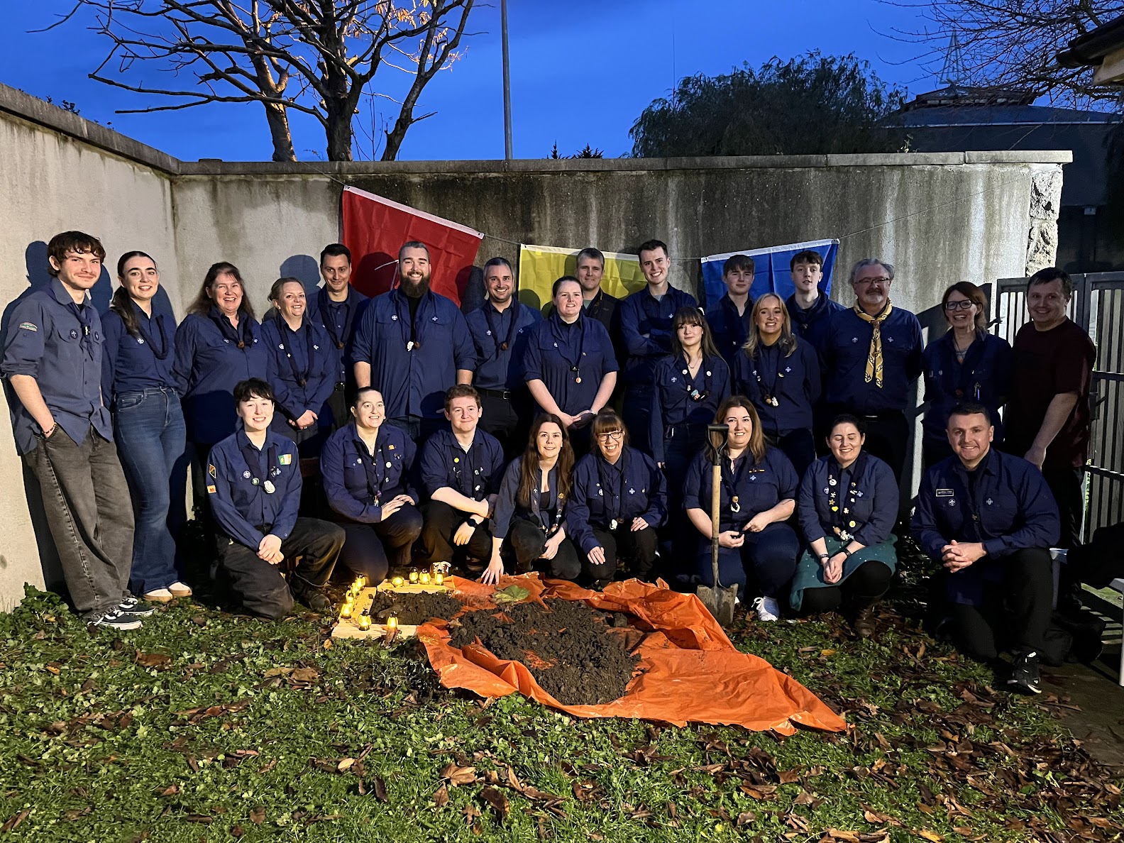 Leaders gathered in the garden at dusk for the time capsule burial at the 50th anniversary