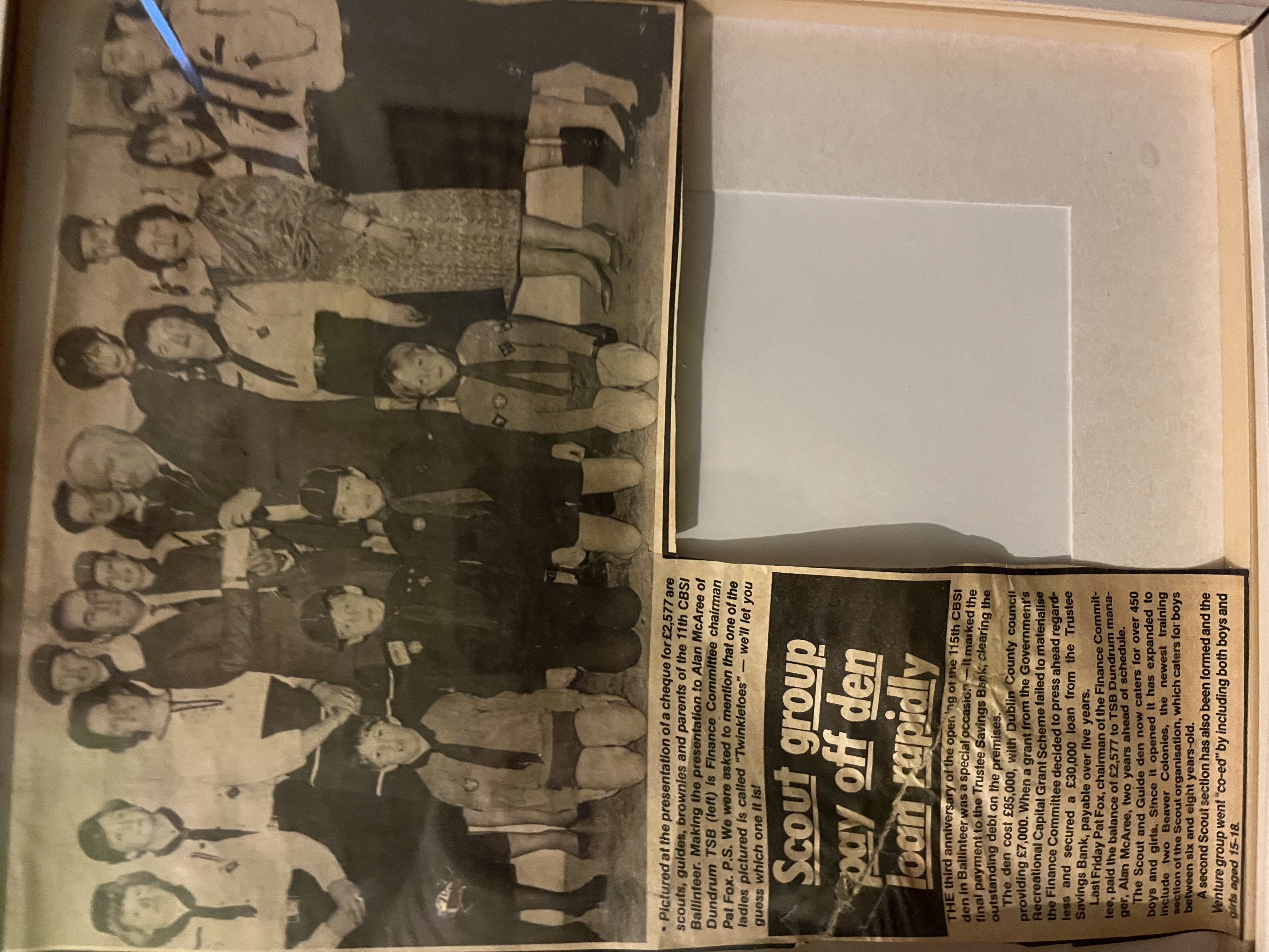 Newspaper clipping and archive photos from the history display